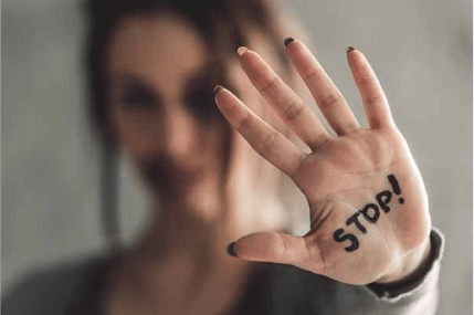 Woman with Stop! written on her hands