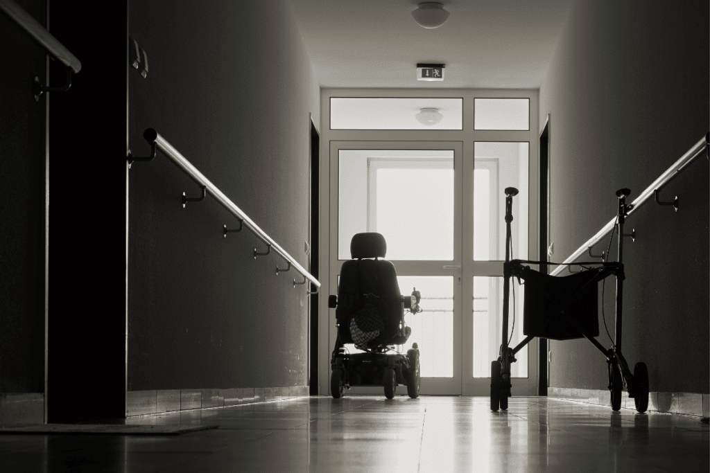 Black and white photo of wheel chair and walker in nursing home