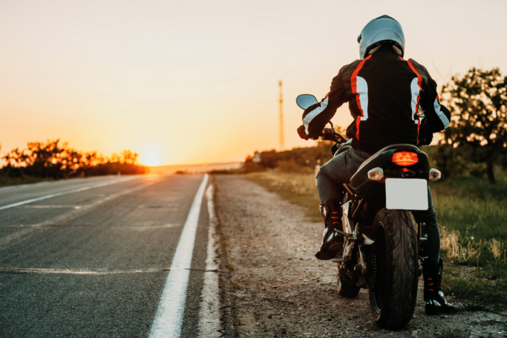 Motorcyclist riding in the sunset