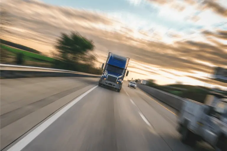 blurry semi-truck speeding on highway