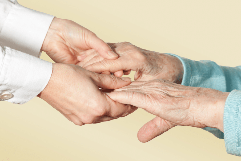 Closeup image of holding a seinor's hands at an Oakland nursing home