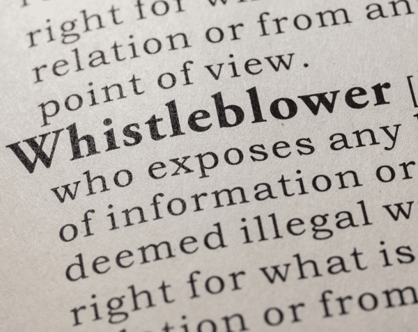 Photo of a dictionary with the definition of a whistleblower