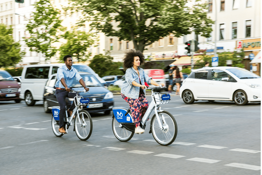 Photo of a couple riding on bicycles through Oakland