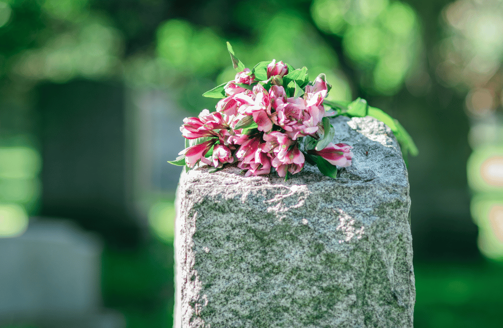 Photo showing flowers on a headstone in an Oakland cemetery