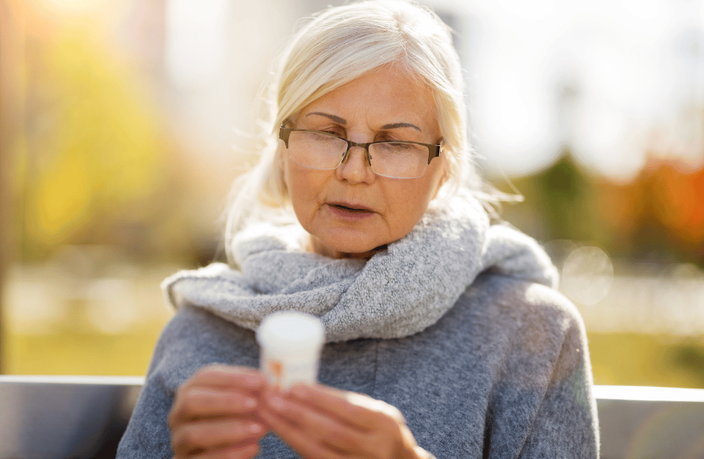 Elderly woman reading prescription on a bottle