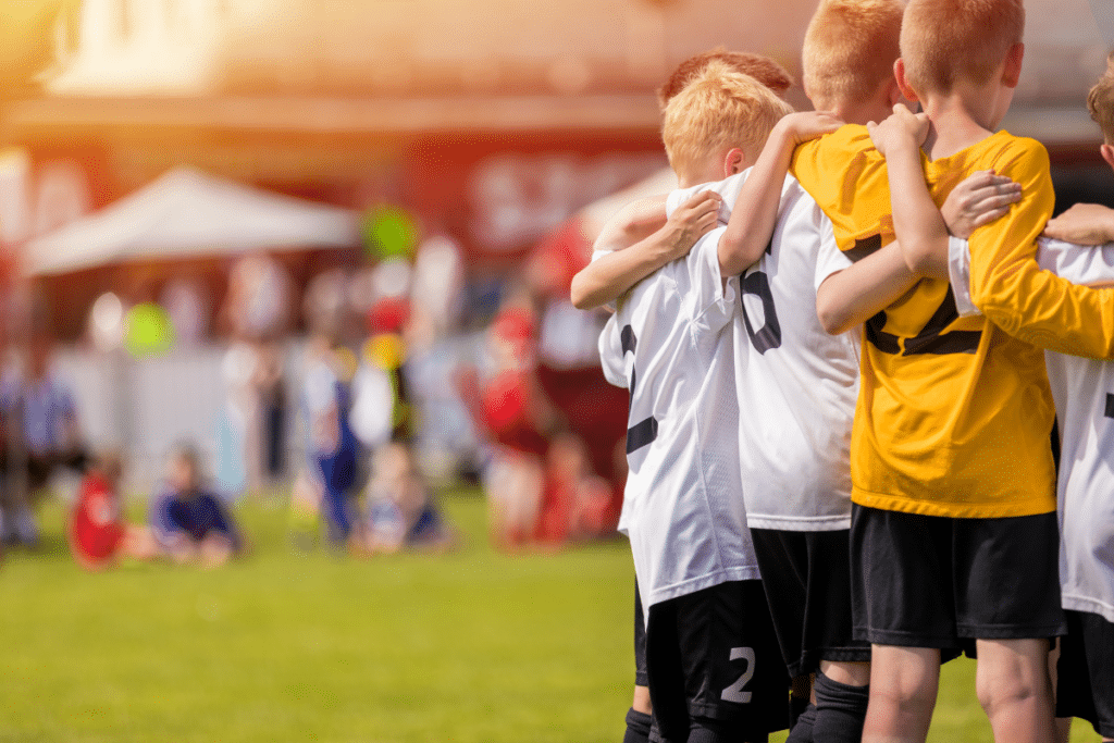 Youth sports soccer team in huddle