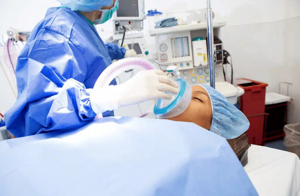 an anesthesiologist holding a mask over a person's nose