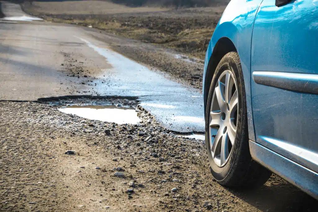 Car approaching a pothole