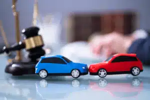 Two toy cars facing each other head on on a desk