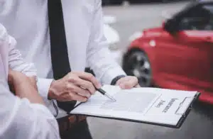 Two men looking at clipboard