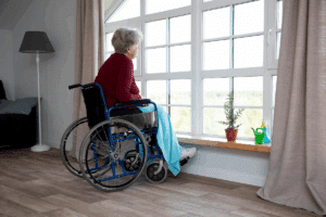 Elderly woman looking out window