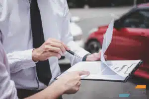 Two people reviewing paperwork on a clipboard