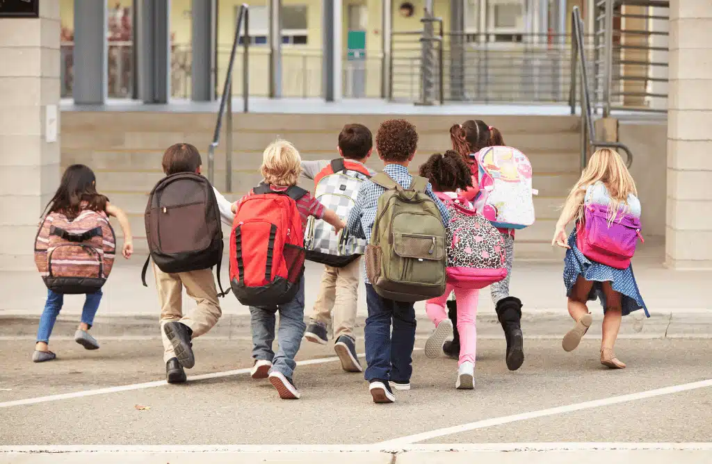Kids running into a school