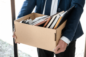 Man packing up work supplies after wrongful termination