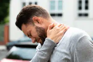 Man grabbing neck in pain