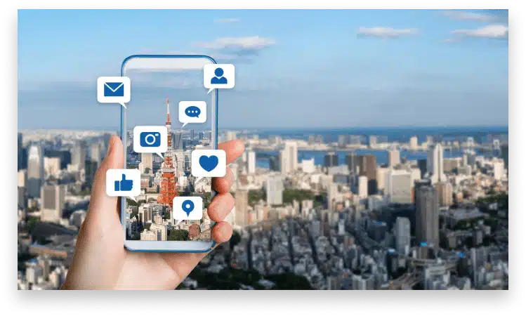 a hand holding a smartphone showing social media icons