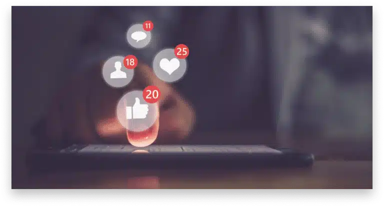 A person tapping on a smartphone with social media icons above the screen