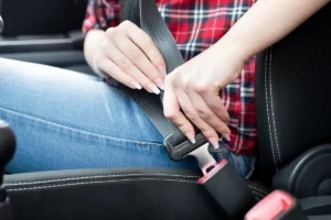 Closeup of person buckling their seat belt