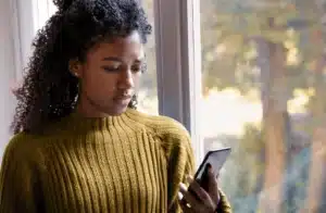 Woman reading a social media content on her phone