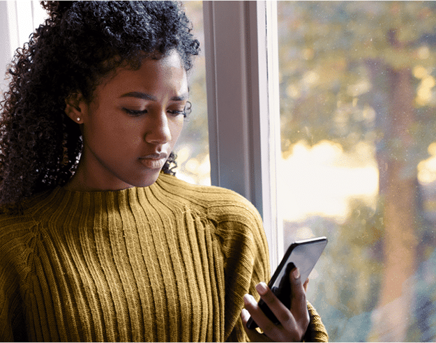 Woman reading a social media content on her phone