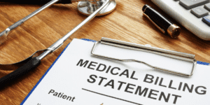 Clipboard with medical bills on desk