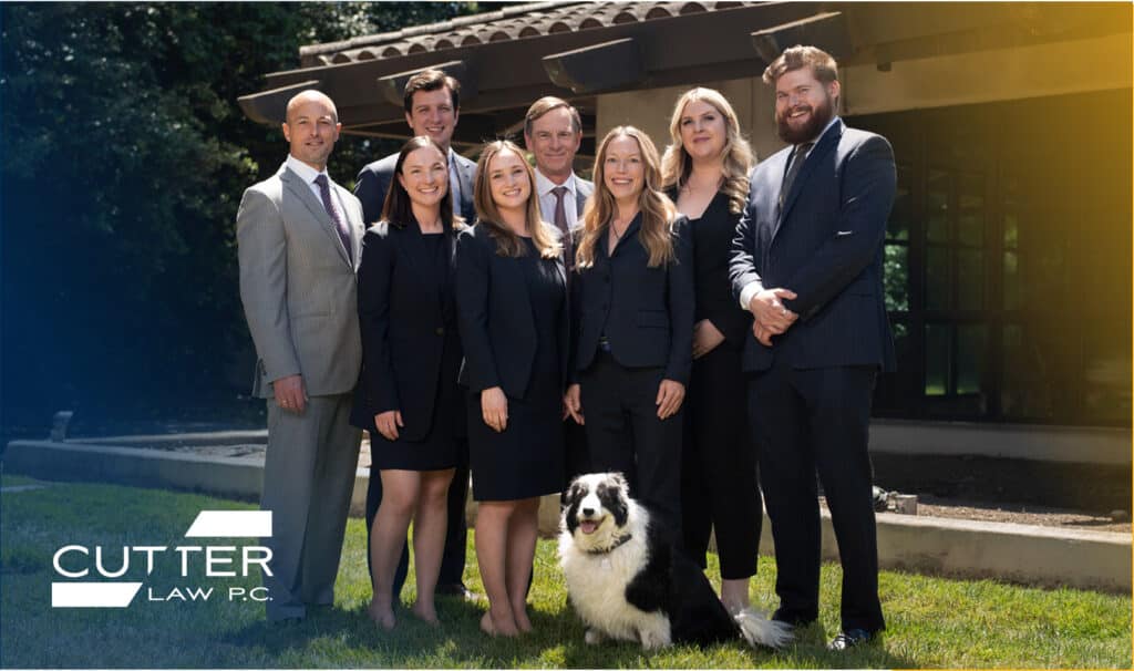Full picture of Cutter Law Attorneys standing outside with a dog