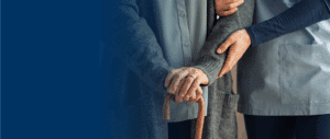 Close up of elderly person and a nurse holding their arm