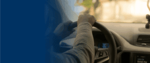 Closeup of persons hands on the wheel